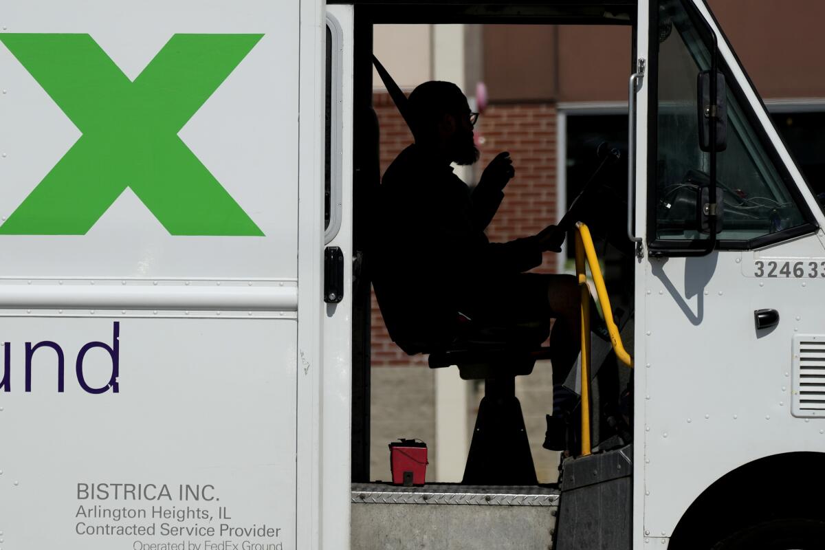 A FedEx driver sitting in a truck
