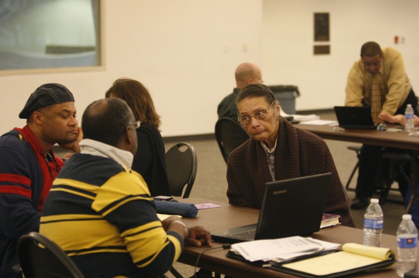 Healthcare reform specialists help people select insurance plans at an Affordable Care Act enrollment fair at Pasadena City College in 2013.