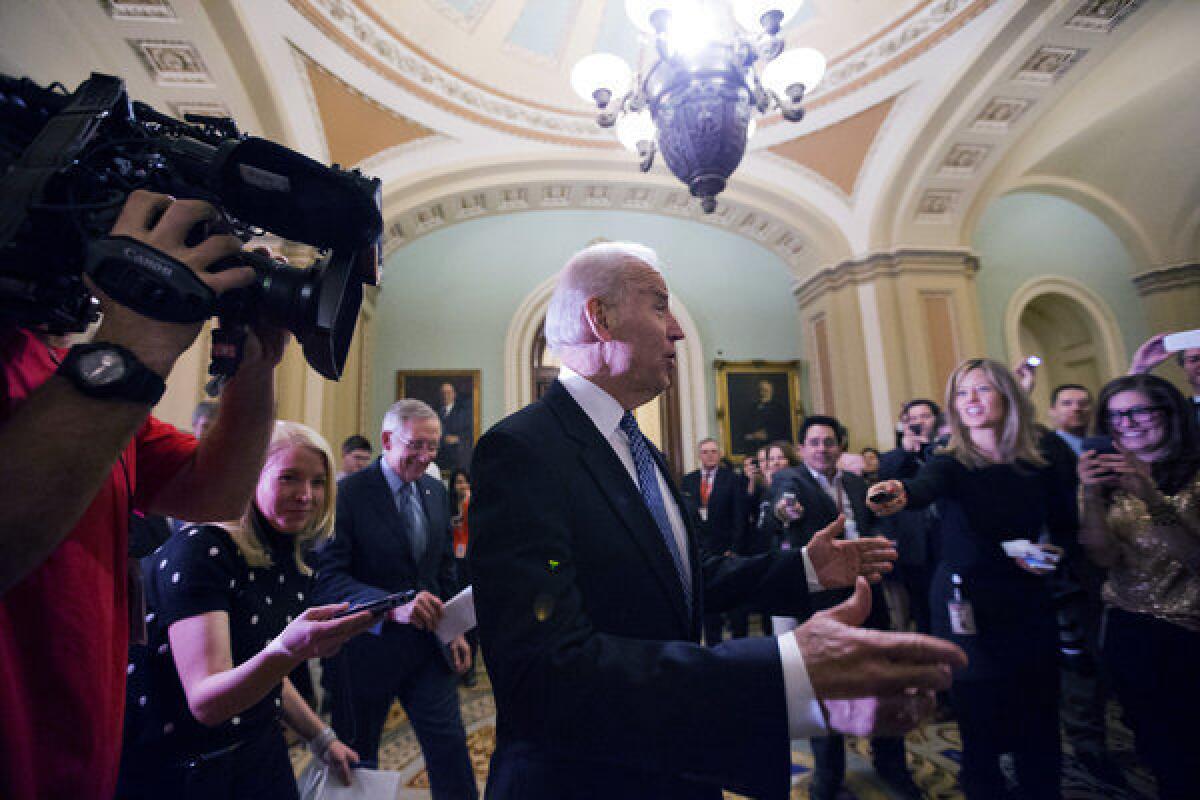 Vice President Joe Biden and Senate Majority Leader Harry Reid arrive for a Senate Democratic caucus meeting.