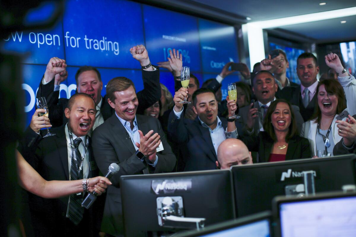 Employees react as public stock trading on Zoom Video Communications Inc. begins on April 18, 2019.