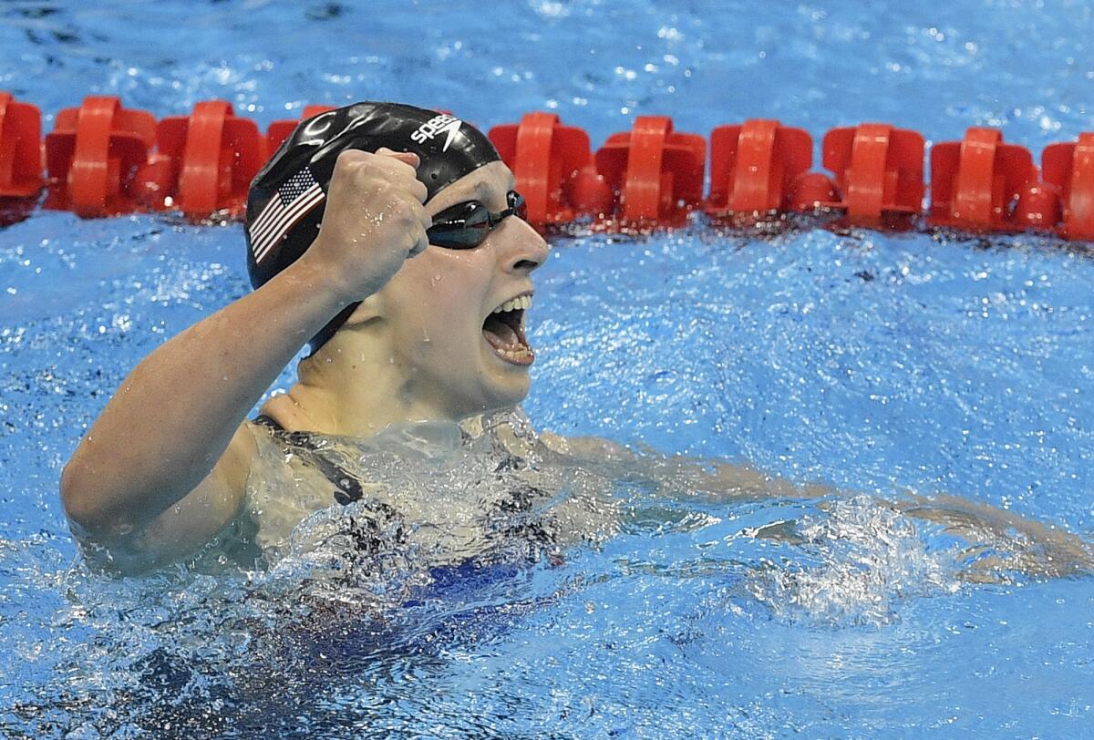 American Katie Ledecky celebrates after winning the gold medal in the 400-meter freestyle in world-record time.