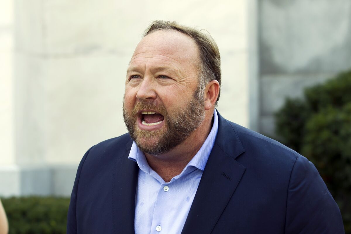 FILE - Infowars host and conspiracy theorist Alex Jones speaks outside of the Dirksen building on Capitol Hill, in Washington, Sept. 5, 2018. Jones will be getting back the $75,000 in fines he paid to a Connecticut court for failing to appear at a deposition last month in a lawsuit over his assertions that the Sandy Hook Elementary School shooting was a hoax, a judge has ruled, Thursday, April 14, 2022. (AP Photo/Jose Luis Magana, File)