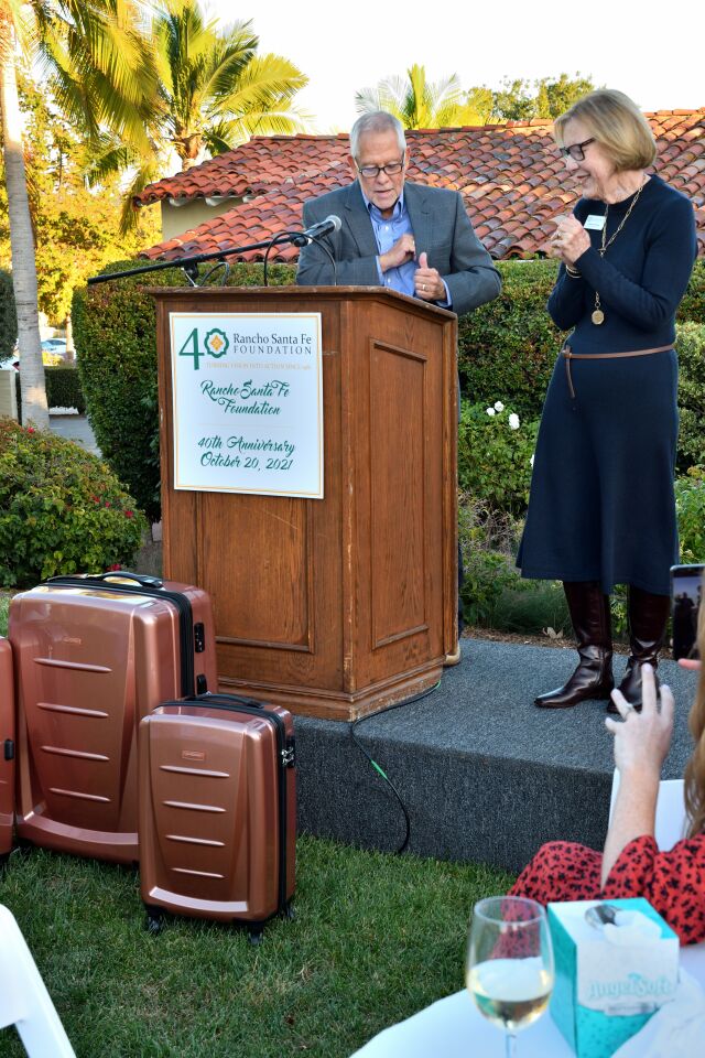 Christy Wilson (former RSFF president/CEO) being presented with a gift of luggage by Kevin Crawford (RSFF board chair)