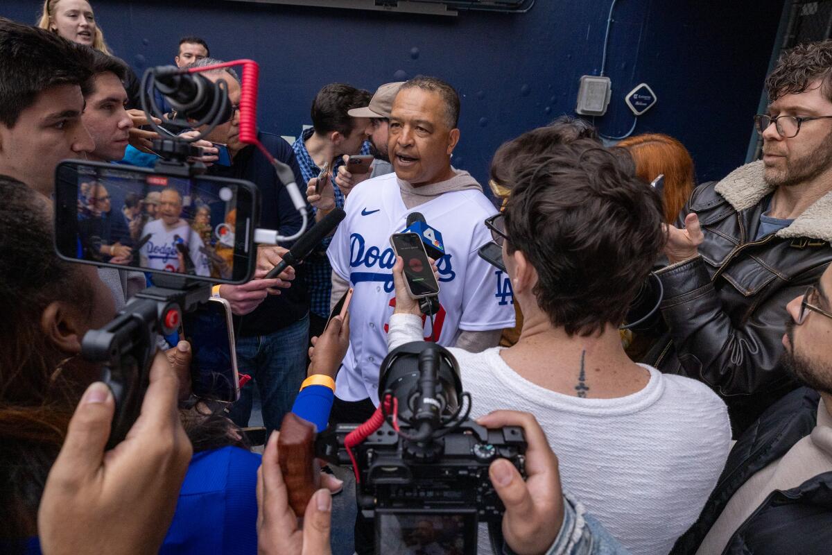 Dodgers manager Dave Roberts speaks to reporters during DodgerFest at Dodger Stadium on Saturday.