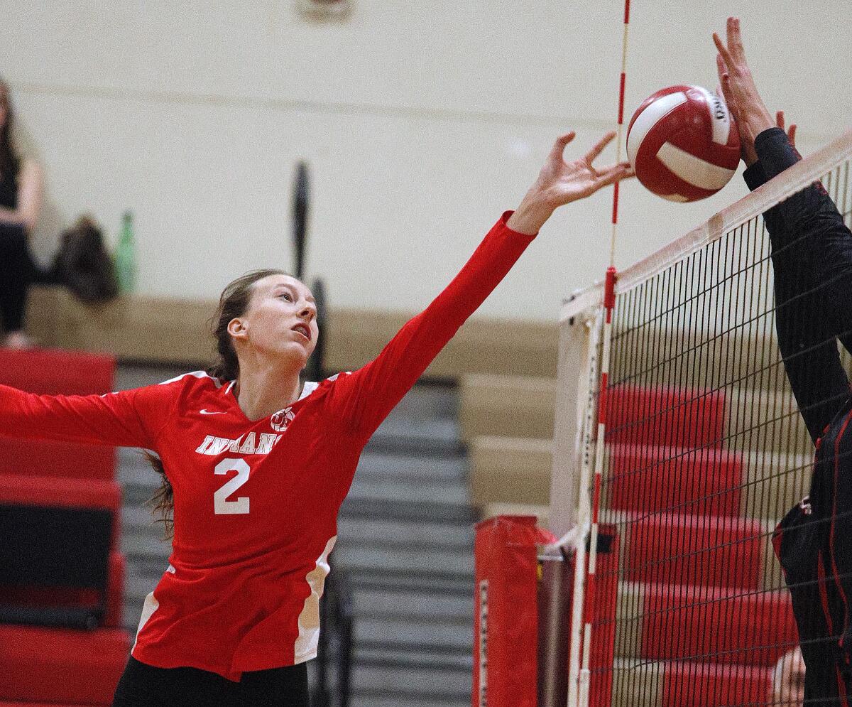 Burroughs' Lydia Grote reaches to attempt to get the ball passed the defense of Murrieta Valley in a CIF Division II playoff girls' volleyball match at Burroughs High School on Thursday, October 24, 2019. Murrieta Valley won the match 3-0.