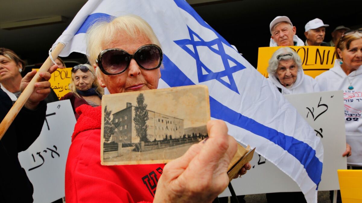 Holocaust survivor Malkah Gorka holds a picture from her school days in Poland during a protest in front of the Polish Embassy in Tel Aviv on Feb. 8.
