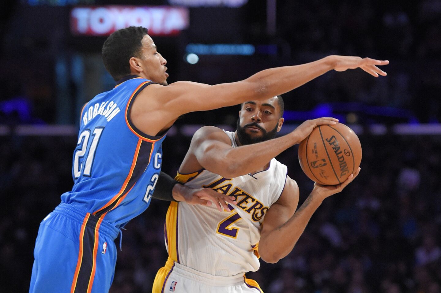Lakers shooting guard Wayne Ellington tries to pass around Thunder guard Andre Roberson during a March 1 game at Staples Center.