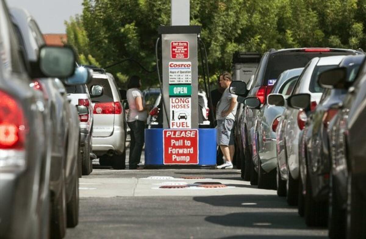 Costco members fill up in Van Nuys on a day last October when gasoline prices hit a record high for the state. Ford is now offering $25,000 for the best phone app for fuel efficiency.