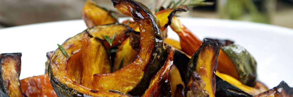 Roasted kabocha squash with a sprig of rosemary.