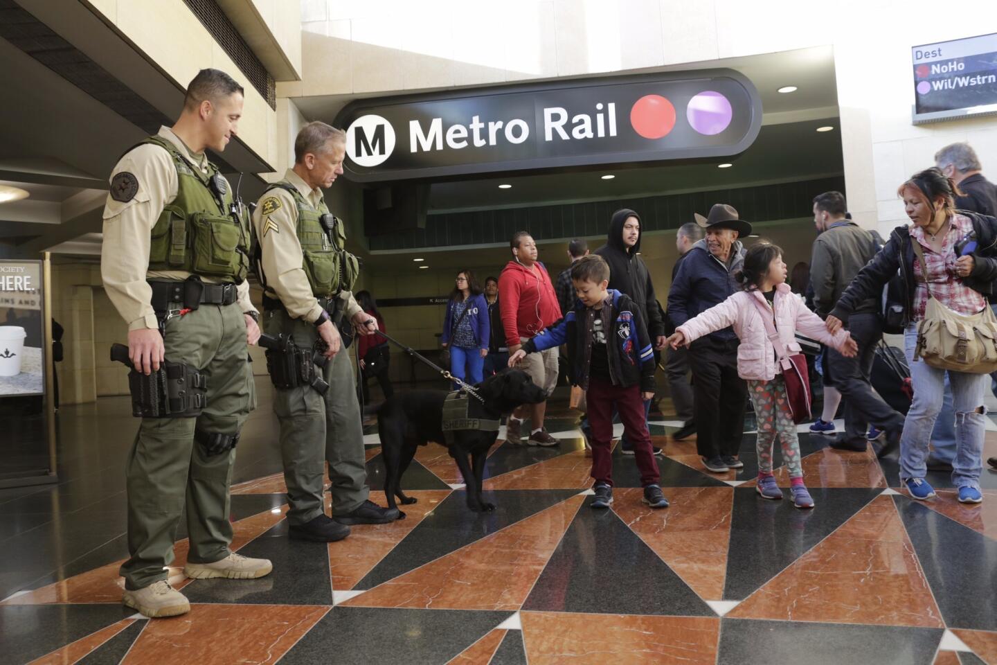 Los Angeles County sheriff's transit police stand by the entrance to the Metro Red and Purple lines Tuesday morning as an added measure of security following terrorist attacks in Brussels.
