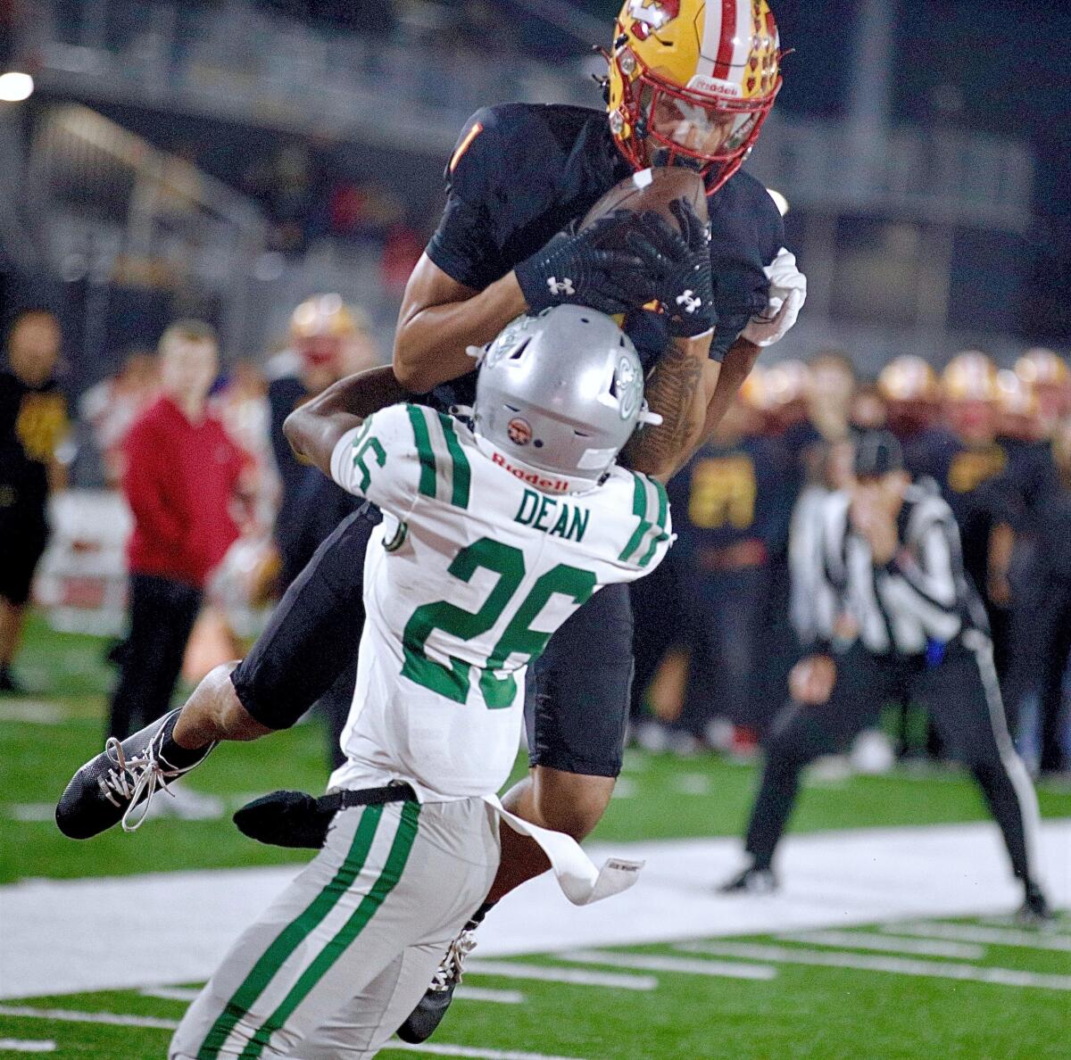Mission Viejo wide receiver Phillip Bell catches a pass in the end zone over De La Salle defender Ant Dean.