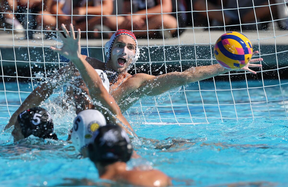 Goalie Conner Clougherty (1) of Newport Beach Water Polo Club makes a one handed save early in Tuesday's game.