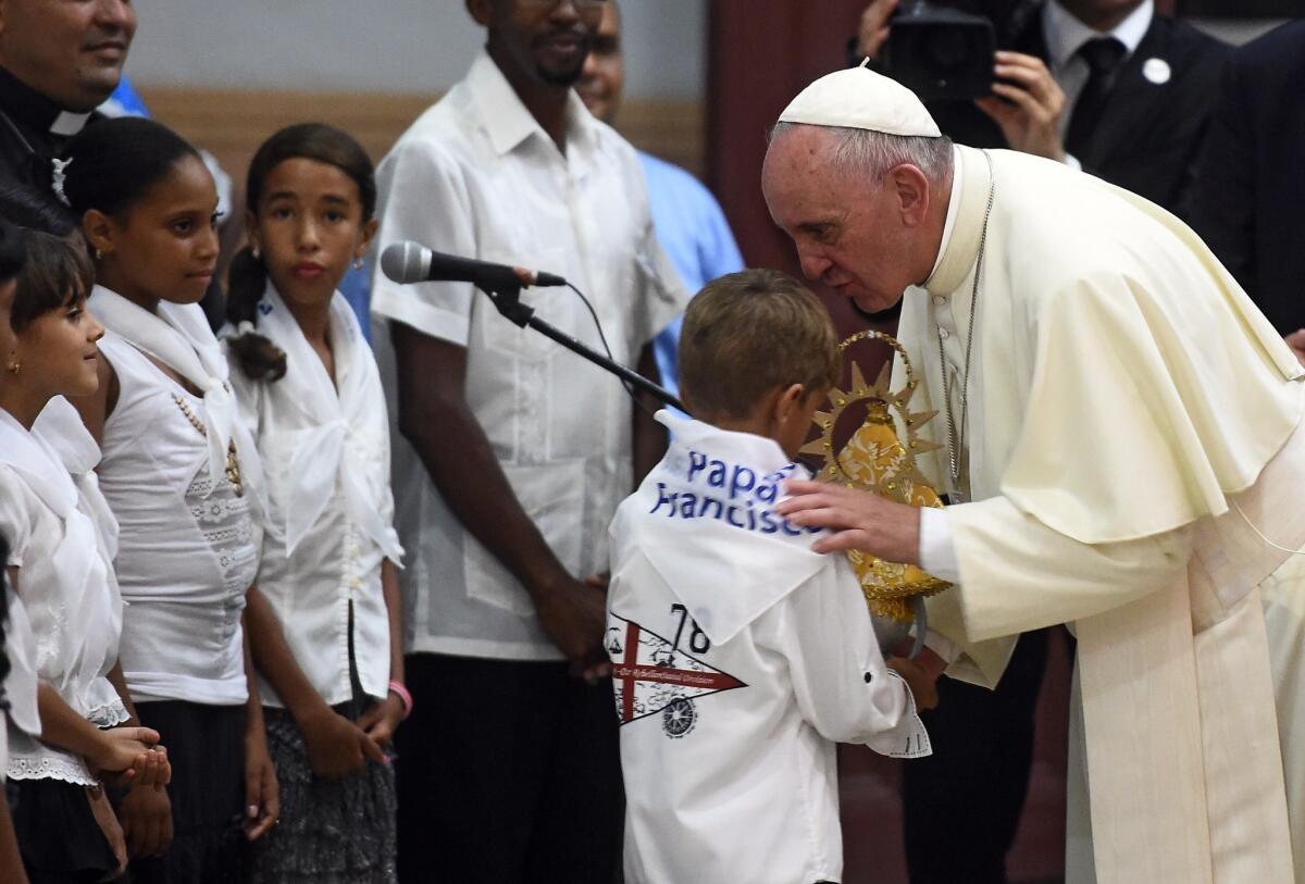 Pope Francis greets children at the basilica of Our Lady of Charity of El Cobre -patron saint of Cuba- in El Cobre, Santiago de Cuba on September 21, 2015. Santiago, the last stop on Pope Francis's Cuban tour, is known for its revolutionary history, its rum and the troubadours who have infused the Caribbean island's music with their tropical beats. Santiago, the last stop on Pope Francis's Cuban tour, is known for its revolutionary history, its rum and the troubadours who have infused the Caribbean island's music with their tropical beats. AFP PHOTO / FILIPPO MONTEFORTEFILIPPO MONTEFORTE/AFP/Getty Images ** OUTS - ELSENT, FPG - OUTS * NM, PH, VA if sourced by CT, LA or MoD **