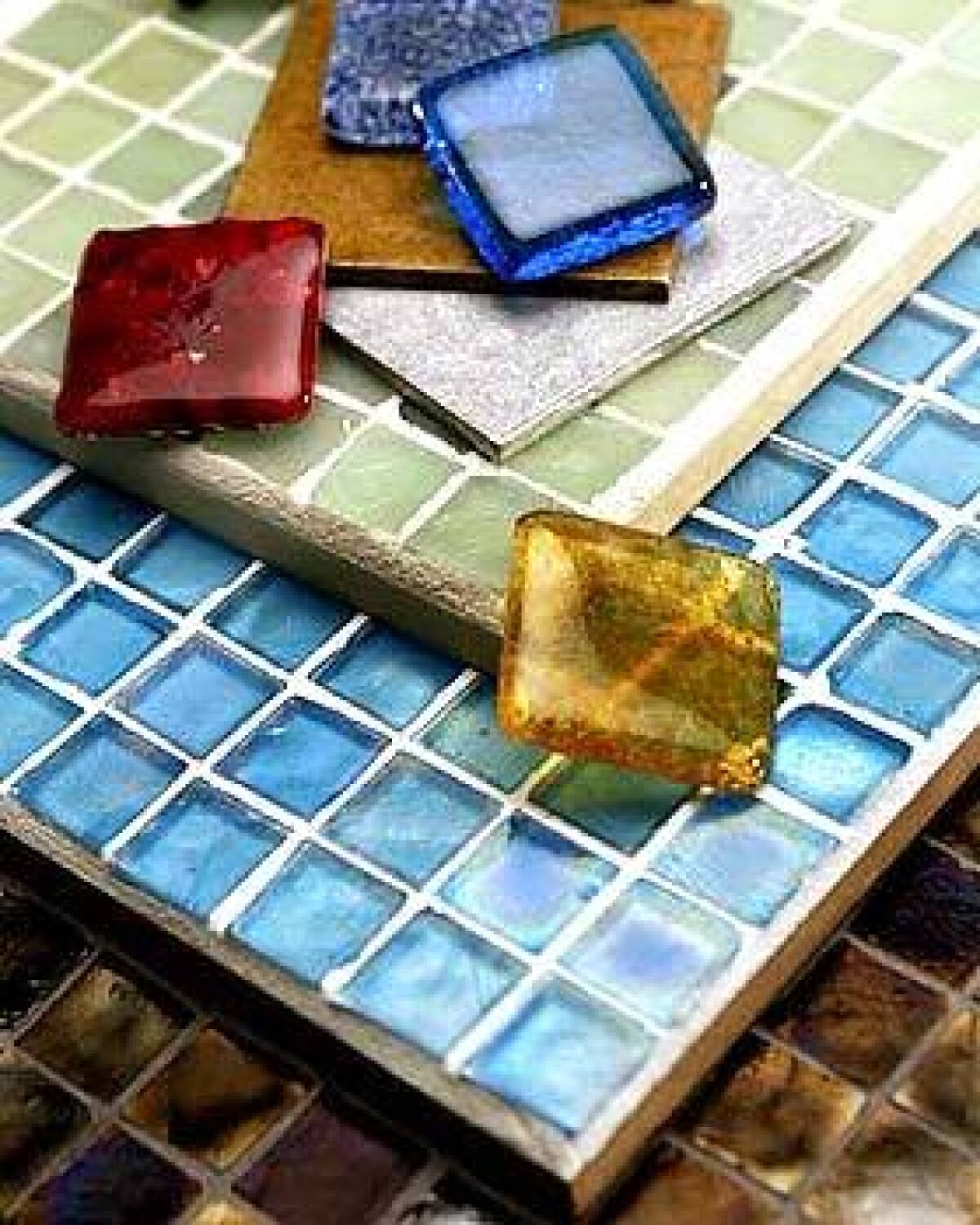 Tiles made from 100% recycled glass in more than 50 colors, from $60 per square foot, are also sold individually as 2-by-2-inch accents, shown here. Four-inch squares of recycled brass, $45, and aluminum, $25 per square foot, come in polished, sandblasted and matte finishes. All from www.ecofriendlyflooring.com, (866) 250-3273. One-inch recycled glass Tessera mosaic tiles in Midori green, aqua and bronze iridescent finishes, from $28 per square foot. For dealers, go to www.glasstile.com or call (866) 648-8453.