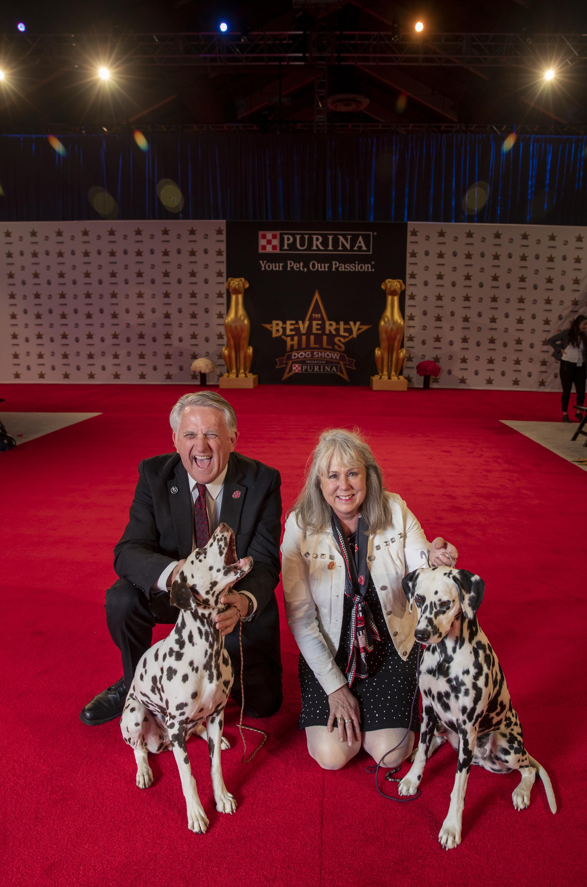 Walt Freshour, of Lake Forest, and Carrie Jordan, of Garden Grove, show off Dalmatians Candy and Coco.