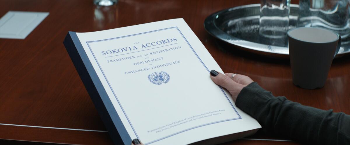 A hand holding the Sokovia Accords in "Captain America: Civil War."