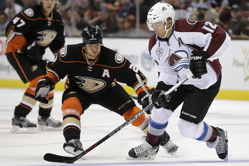 Colorado Avalanche's Jarome Iginla, right, moves the puck under pressure by Anaheim Ducks' Kevin Bieksa during a preseason hockey game on Oct. 1.
