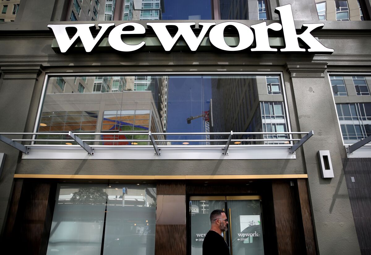 A sign is posted on the exterior of a WeWork office on Oct. 07, 2019, in San Francisco