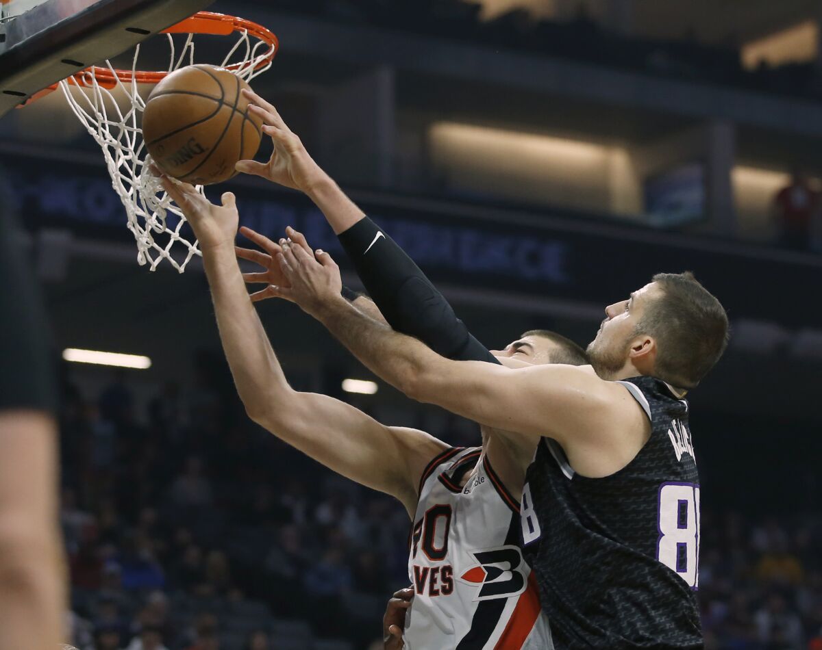 Clippers center Ivica Zubac has the inside track for a rebound against Kings forward Nemanja Bjelica during the first half of a game Dec. 31, 2019.