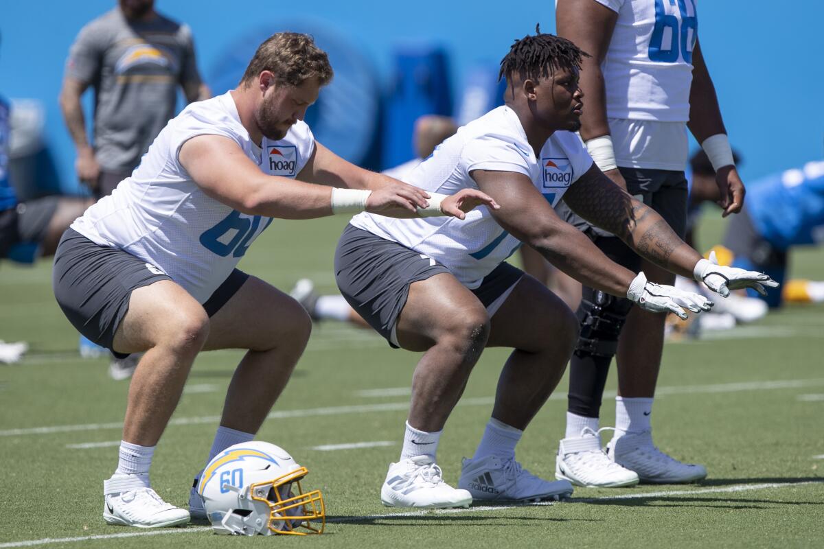 Chargers center Isaac Weaver, left, and offensive guard Zion Johnson take part in drills during minicamp on June 1.