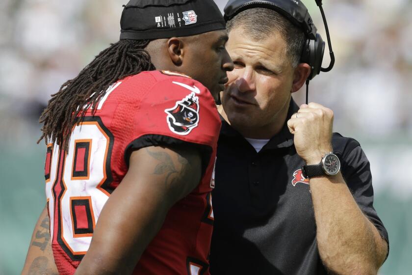 Dashon Goldson, left, speaks with Tampa Bay Buccaneers Coach Greg Schiano during a game against the New York Jets on Sept. 8.