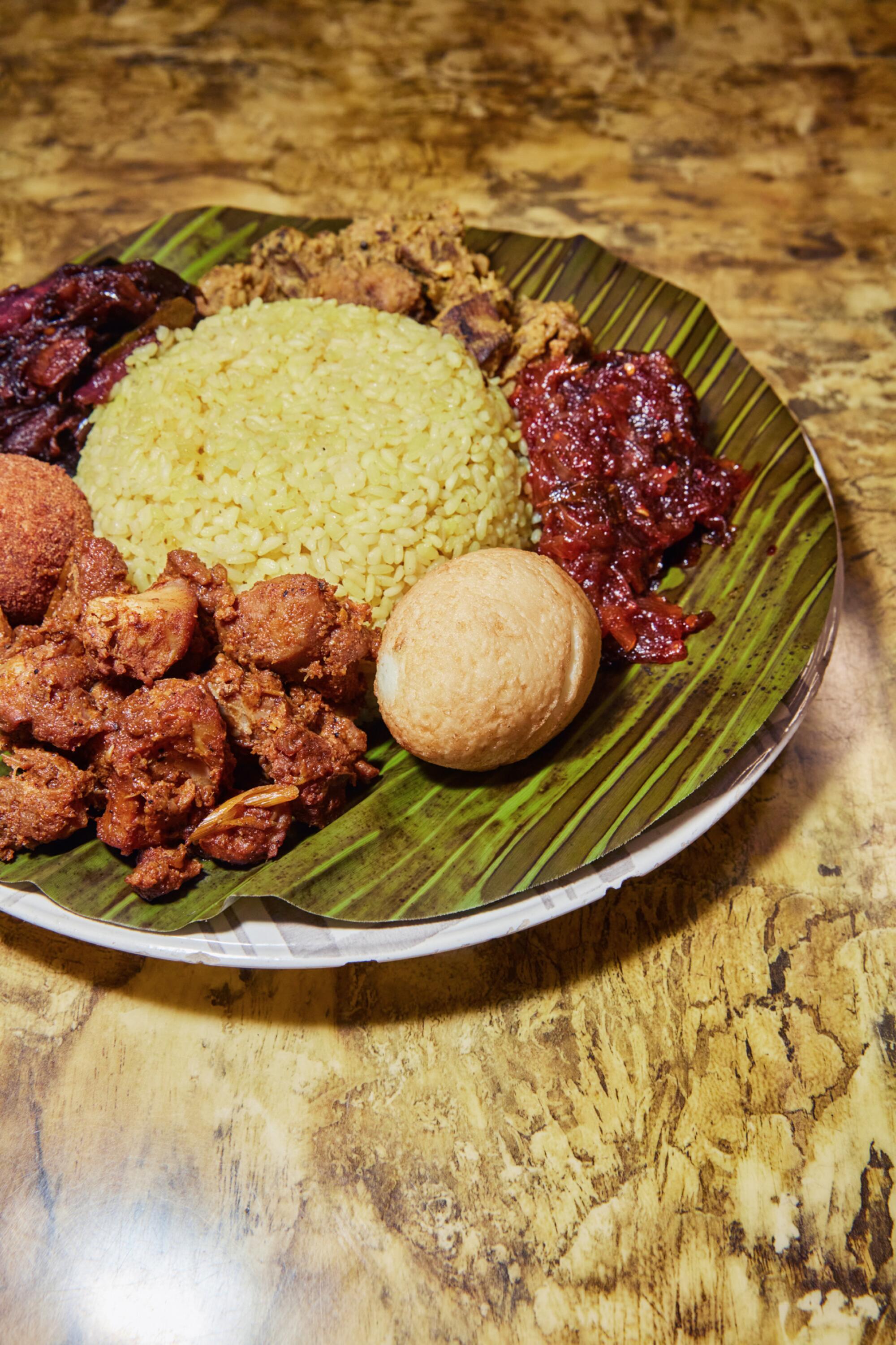 Lamprais, a popular Sri Lankan dish, served with sides on a banana leaf