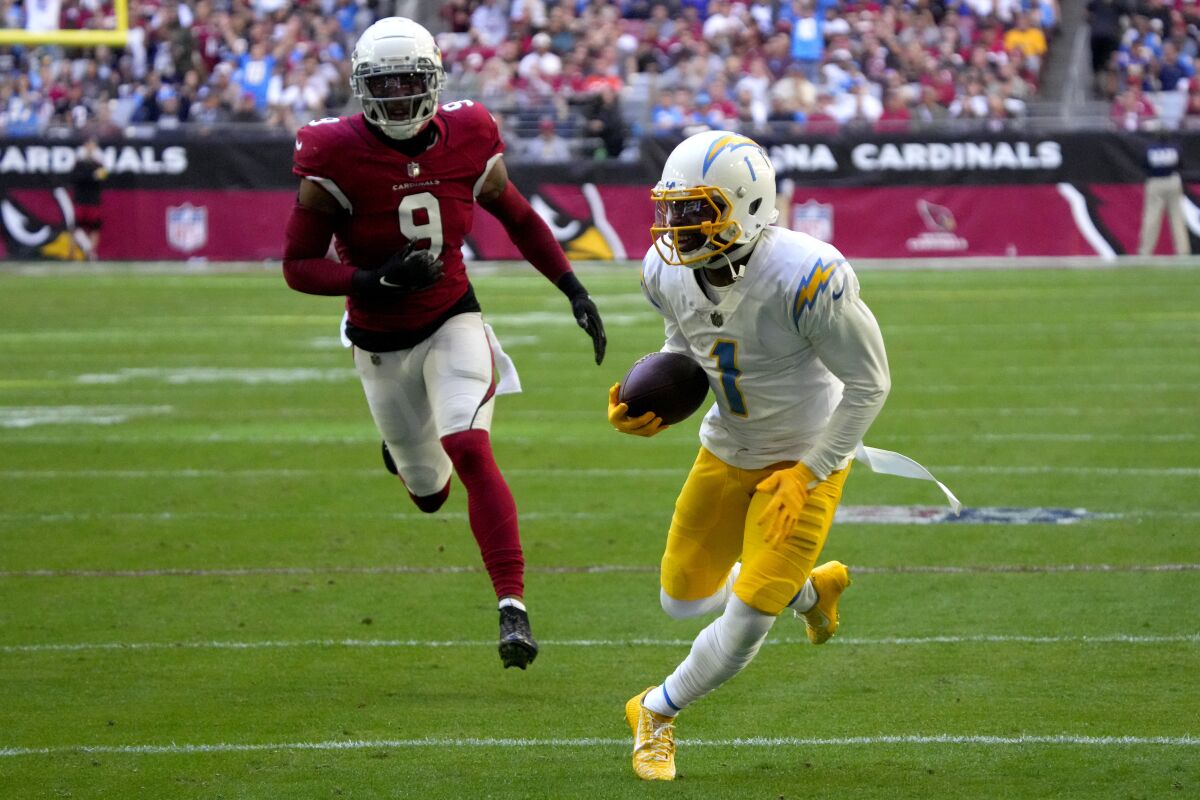 Chargers wide receiver DeAndre Carter runs in for a touchdown as Arizona Cardinals linebacker Isaiah Simmons pursues.