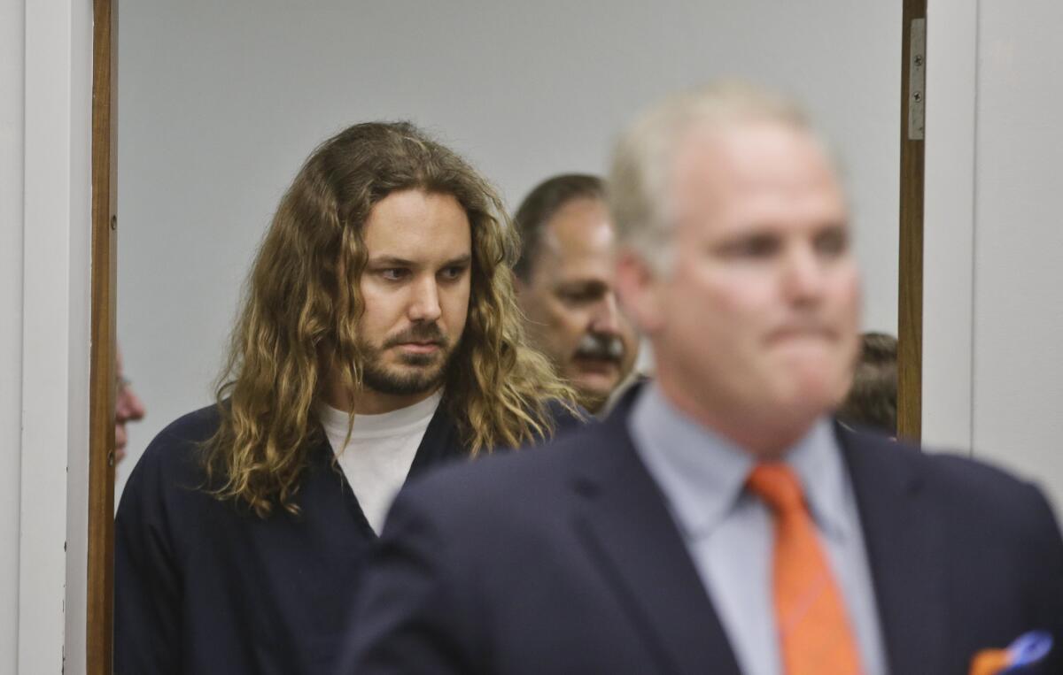 Tim Lambesis, the lead singer for the metal band As I Lay Dying, follows his attorney into Superior Court for his arraignment.
