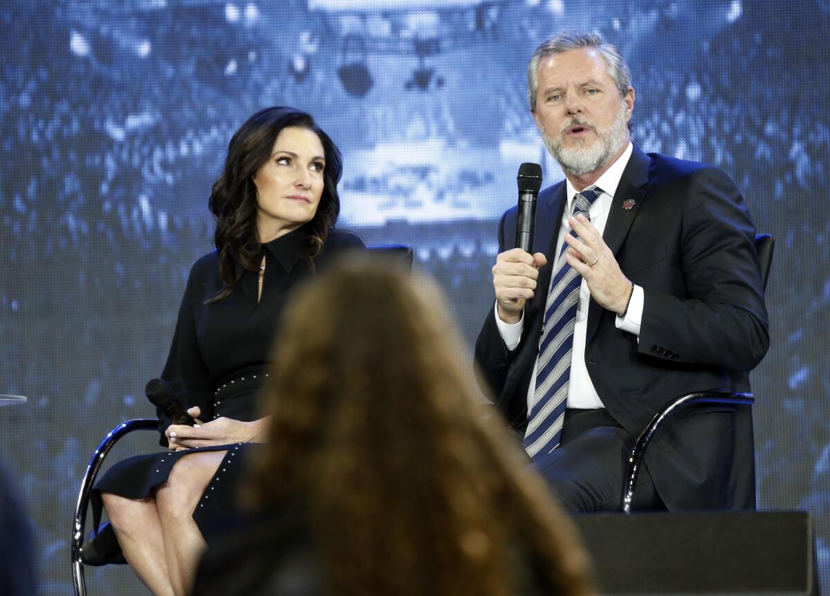 Jerry Falwell Jr., with wife Becki, speaks at a 2018 town hall meeting at Liberty University in Lynchburg, Va.