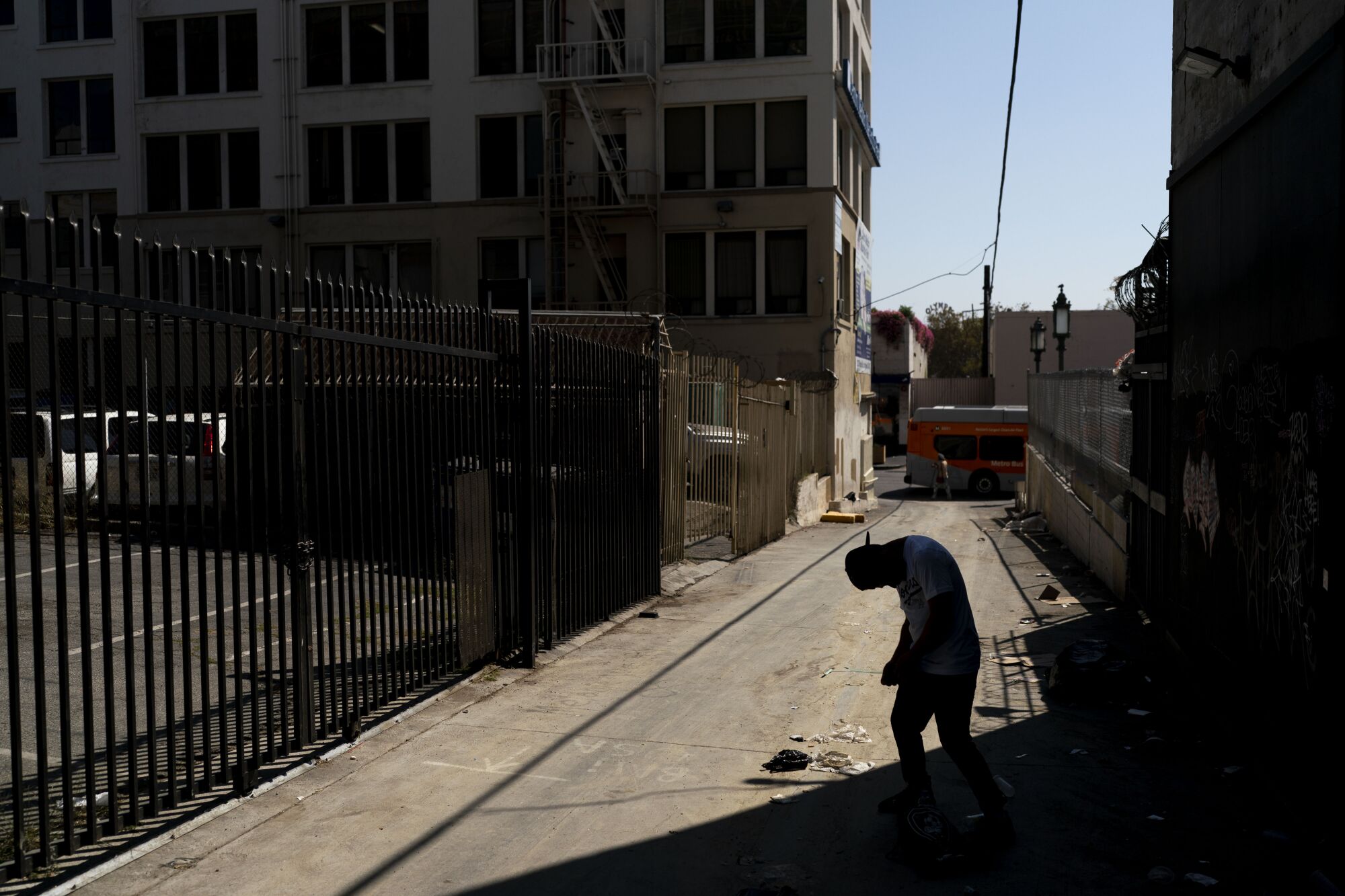 A man falls asleep standing up in an alley after smoking fentanyl.