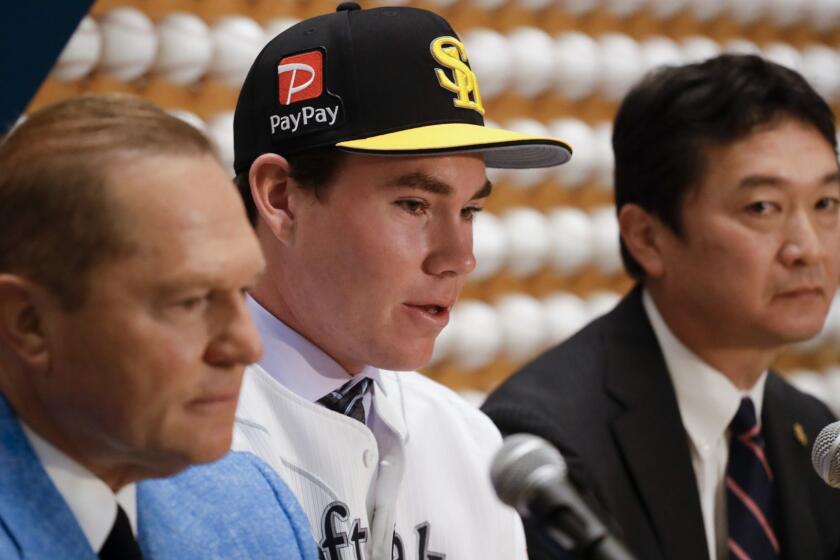 Sports agent, Scott Boras, left, SoftBank Hawks pitcher Carter Stewart Jr., center, and Hawks general manager Sugihiko Mikasa speak during a baseball news conference in Newport Beach, Calif., Thursday, May 30, 2019. After failing to sign with Atlanta and losing a grievance against the Braves, 19-year-old right-hander Carter Stewart has agreed to a six-year contract with the Fukuoka SoftBank Hawks of Japan's Pacific League. (AP Photo/Chris Carlson)