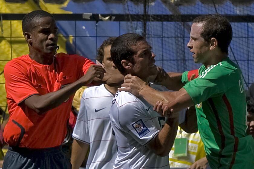 Mexico's Gerardo Torrado fights with American Benny Feilhaber during a FIFA World Cup qualifier at Estadio Azteca 