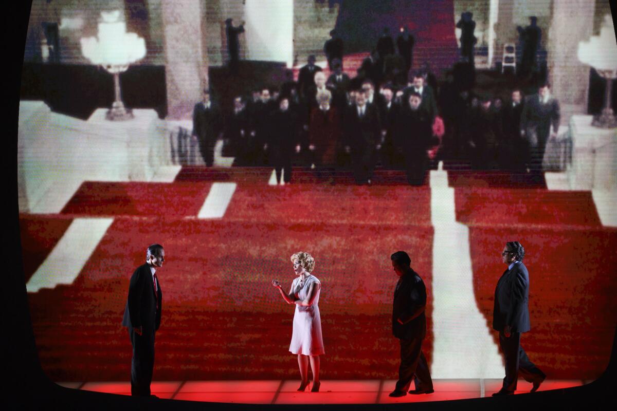 The live cast in the foreground, echoed by historical footage in the background. (Patrick T. Fallon / For The Times)