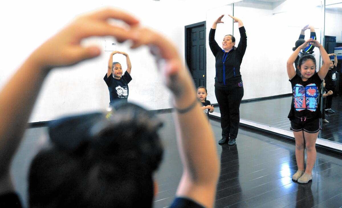 Lourdes Perez, owner of Spotlight Dance Studio in Cudahy, teaches a folkloric dance class. She speaks almost entirely in Spanish, while most of her students, though Latino, speak English.