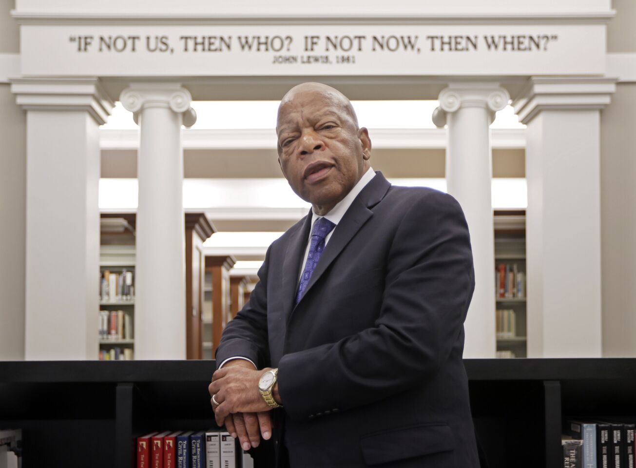 John Lewis stands in front of a quote of his in the Civil Rights Room in the Nashville Public LIbrary