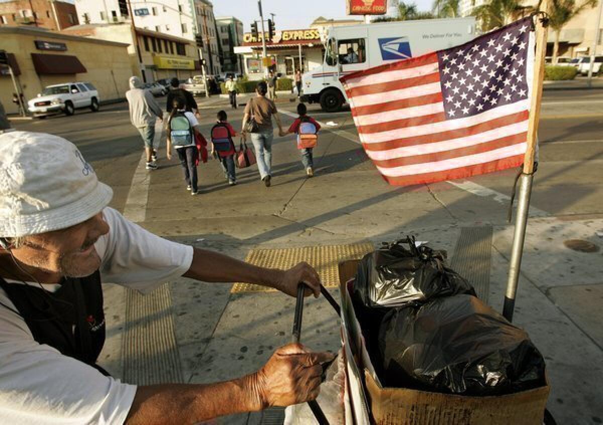 A street vendor wheels a cart in 2007 near the spot where an infant was killed days earlier in a gang-related shooting.