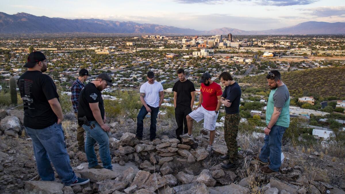 Friends and former volunteer Syrian fighters spend time at the spot where Kevin Howard committed suicide. From the left: Eddie Leachet, Al Arsenault, Donnie Farmer, William Mostoller, Stefan Rivenbark, William Allard, Taylor Hudson and Justin Schnepp. (Gina Ferazzi / Los Angeles Times)