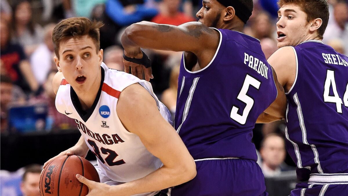 Gonzaga forward Zach Collins looks for room to maneuver as he's defended by Northwestern center Dererk Pardon (5) and forward Gavin Skelly on Saturday.