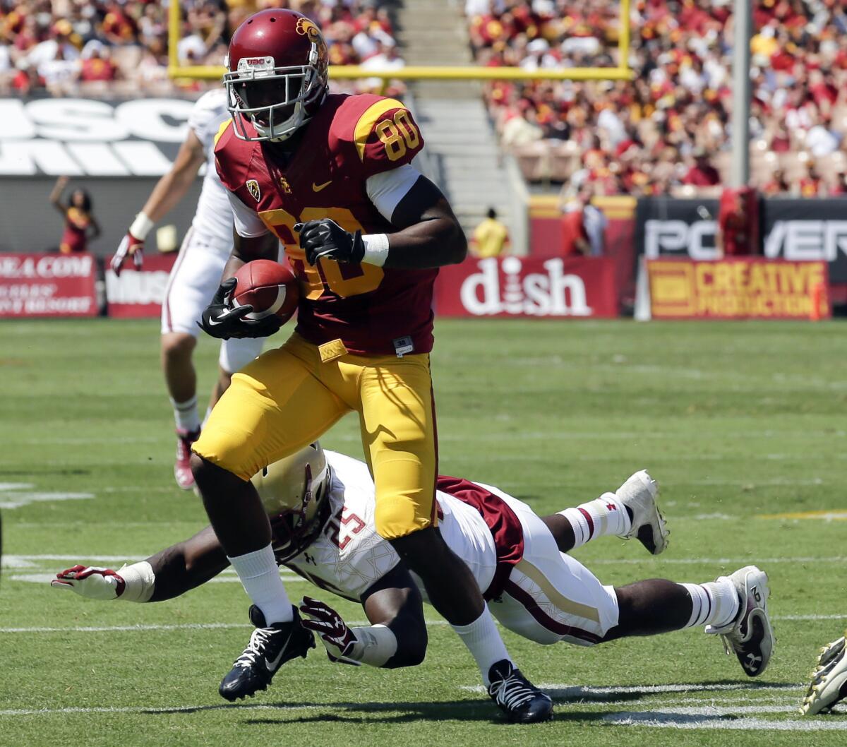 USC wide receiver De'Von Flournoy breaks away from Boston College linebacker Josh Keyes in the first half of their game Saturday at the Coliseum.