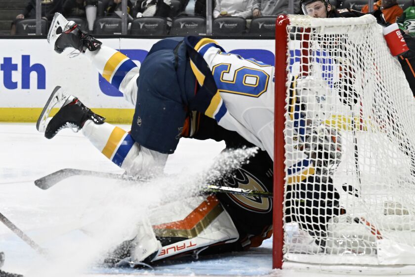 Blues left wing Sammy Blais collides with Ducks goalie John Gibson on a shot attempt in the first period March 25, 2023.
