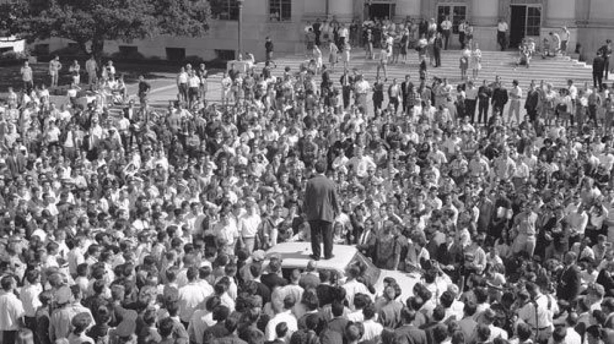 Mario Savio stands atop a police car in front of Sproul Hall on Oct. 1, 1964. (The Bancroft Library / Courtesy of UC Berkeley)