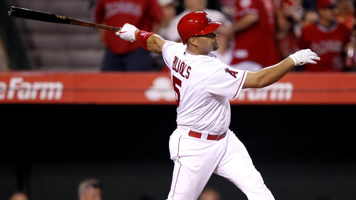 Angels first baseman Albert Pujols follows through on a solo home run against the Tigers in the sixth inning Friday night in Anaheim.