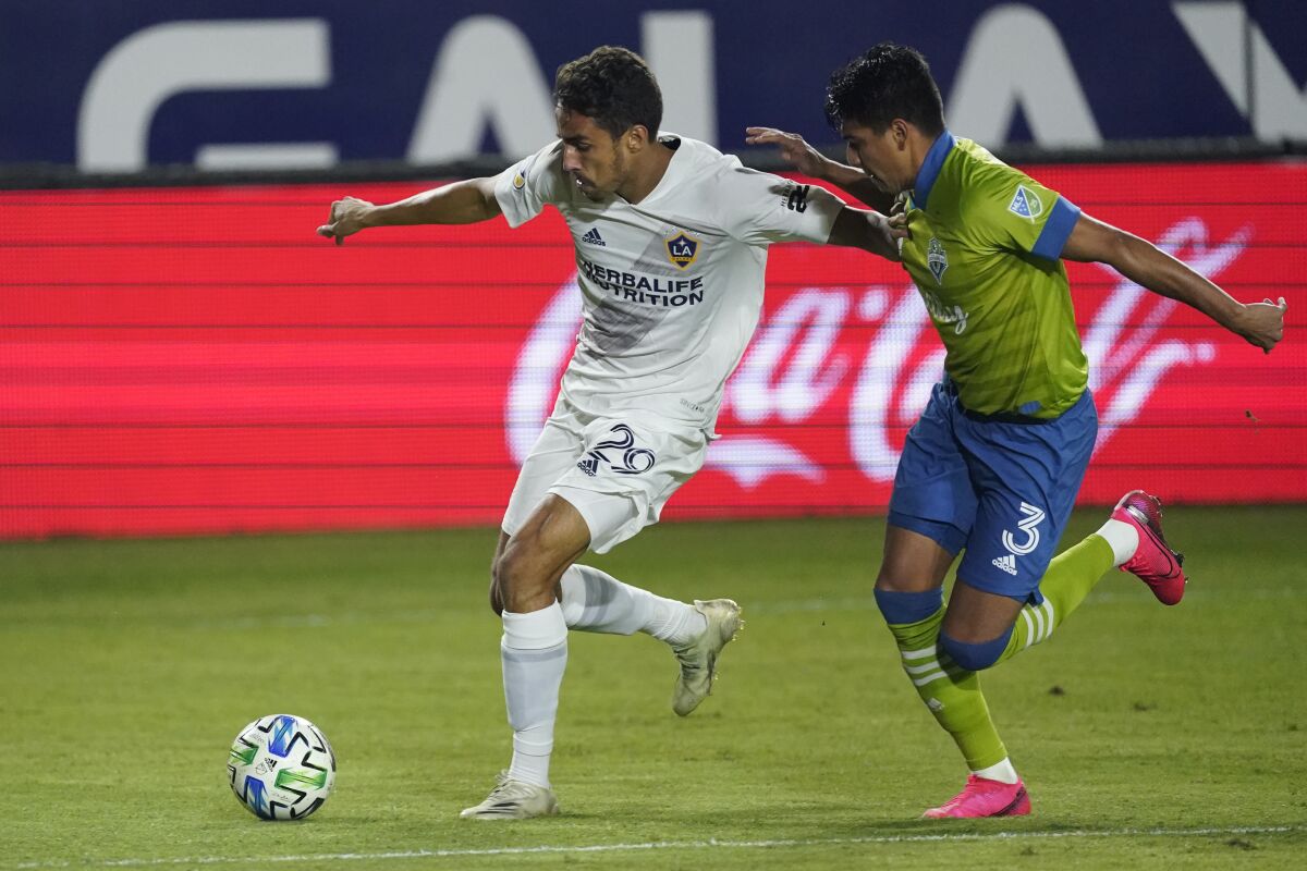 Galaxy forward Ethan Zubak gets control of the ball next to Seattle Sounders defender Xavier Arreaga.