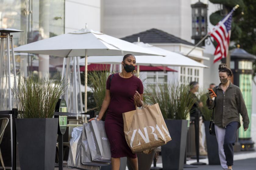 LOS ANGELES, CA - OCTOBER 21: Shoppers walk through The Grove enjoying a beautiful fall day on Thursday, Oct. 21, 2021 in Los Angeles, CA. (Francine Orr / Los Angeles Times)