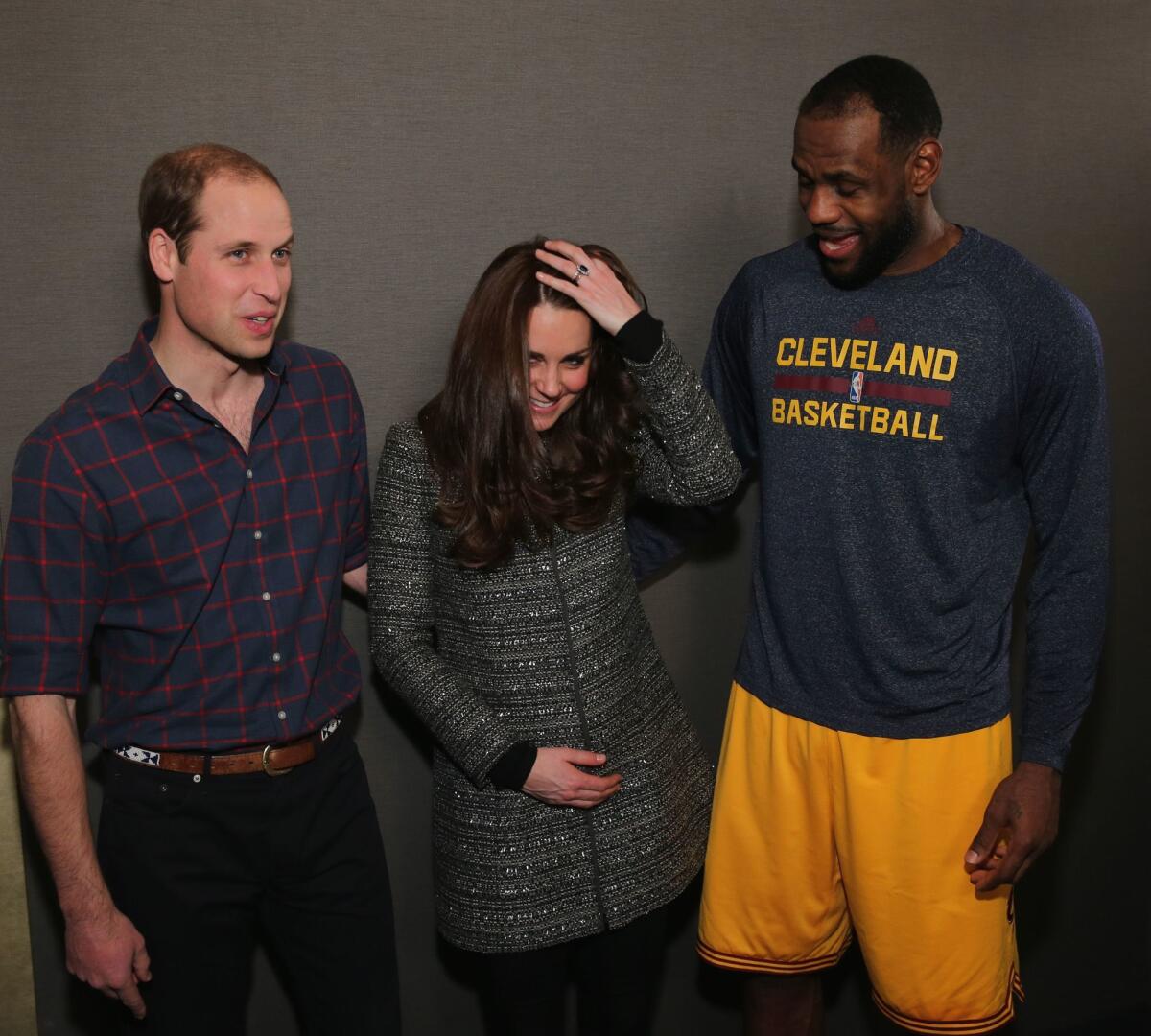Prince William, Duke of Cambridge and Catherine, Duchess of Cambridge pose with LeBron James (R) backstage as they attend the Cleveland Cavaliers vs. Brooklyn Nets game at Barclays Center on December 8, 2014 in the Brooklyn borough of New York City.