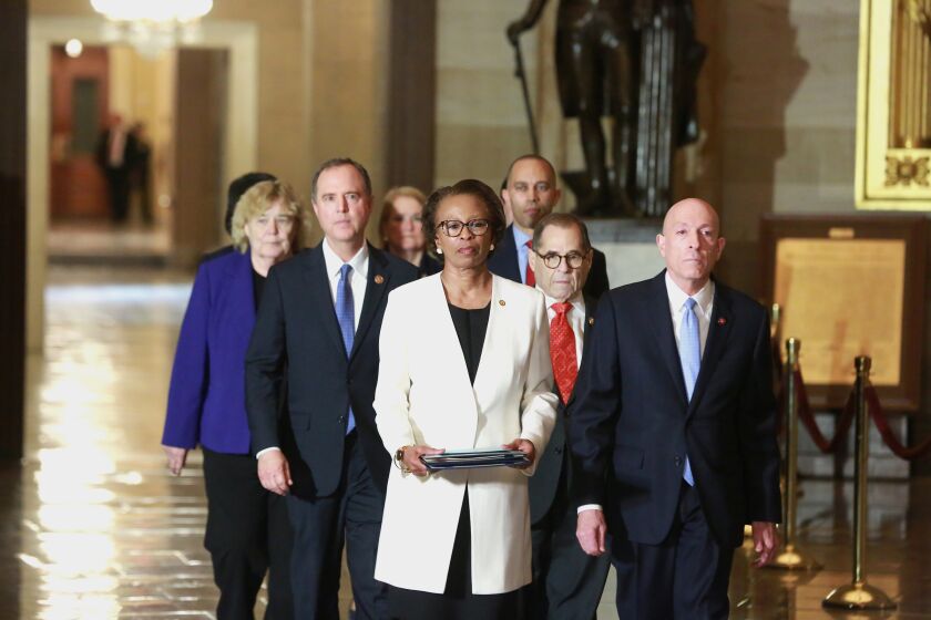 WASHINGTON, DC, JANUARY 15, 2020: Clerk Cheryl Johnson with Sargent-at-arms Paul Erving followed by Adam Schiff and Jerry Nadler fowwowed by the Impeachment managers, lead the procession carrying the Articles of Impeachment from the House of Representatives to the Senate. (Kirk McKoy / Los Angeles Times)