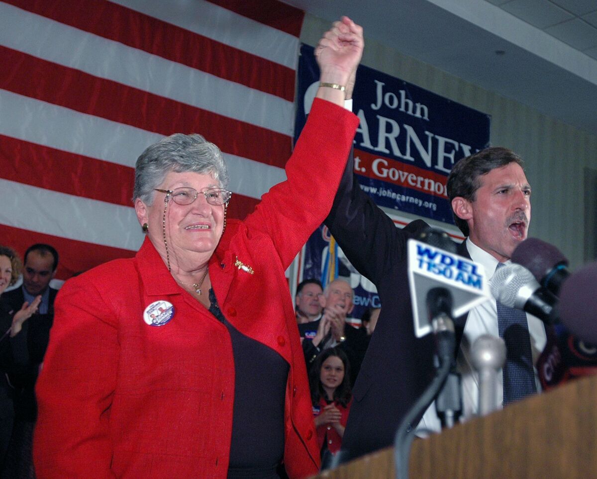 FILE - Delaware Gov. Ruth Ann Minner, left, and Lt. Gov. John Carney raise their arms in victory as they celebrate winning their respective races Tuesday, Nov. 2, 2004, in Wilmington, Del. Ruth Ann Minner, a sharecropper’s daughter who became the only woman to serve as Delaware’s governor, has died. She was 86. Minner passed away Thursday morning, Nov. 4, 2021 according to Agriculture Secretary Michael Scuse, a close friend who once served as her chief of staff. (AP Photo/Pat Crowe II, File)