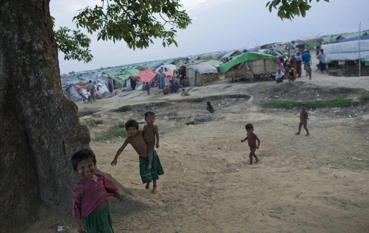 Internally displaced Rohingya children play in the foreground of makeshift tents at a camp in northwestern Rakhine State, Myanmar, earlier this month. Authorities in western Rakhine state have imposed a two-child limit for Muslim Rohingya families, a policy that does not apply to Buddhists in the area.