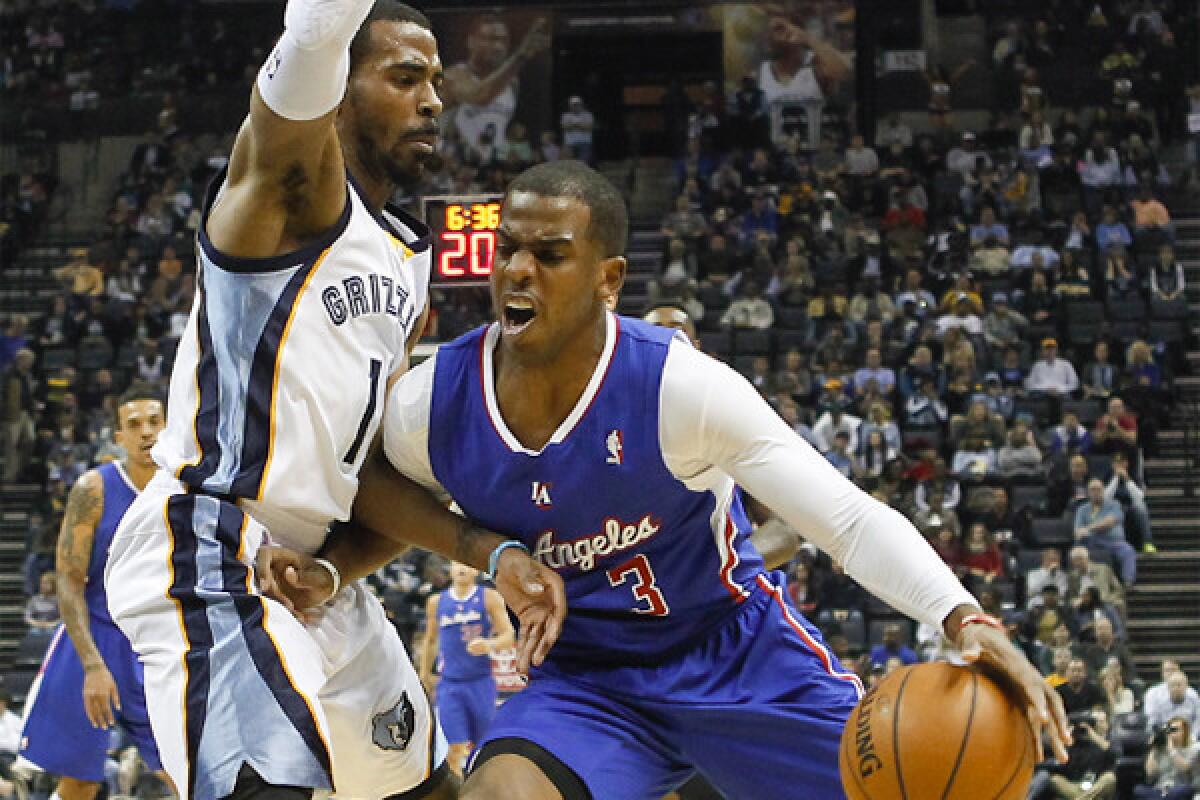Chris Paul goes to the basket against Grizzlies guard Mike Conley on Friday night in Memphis.