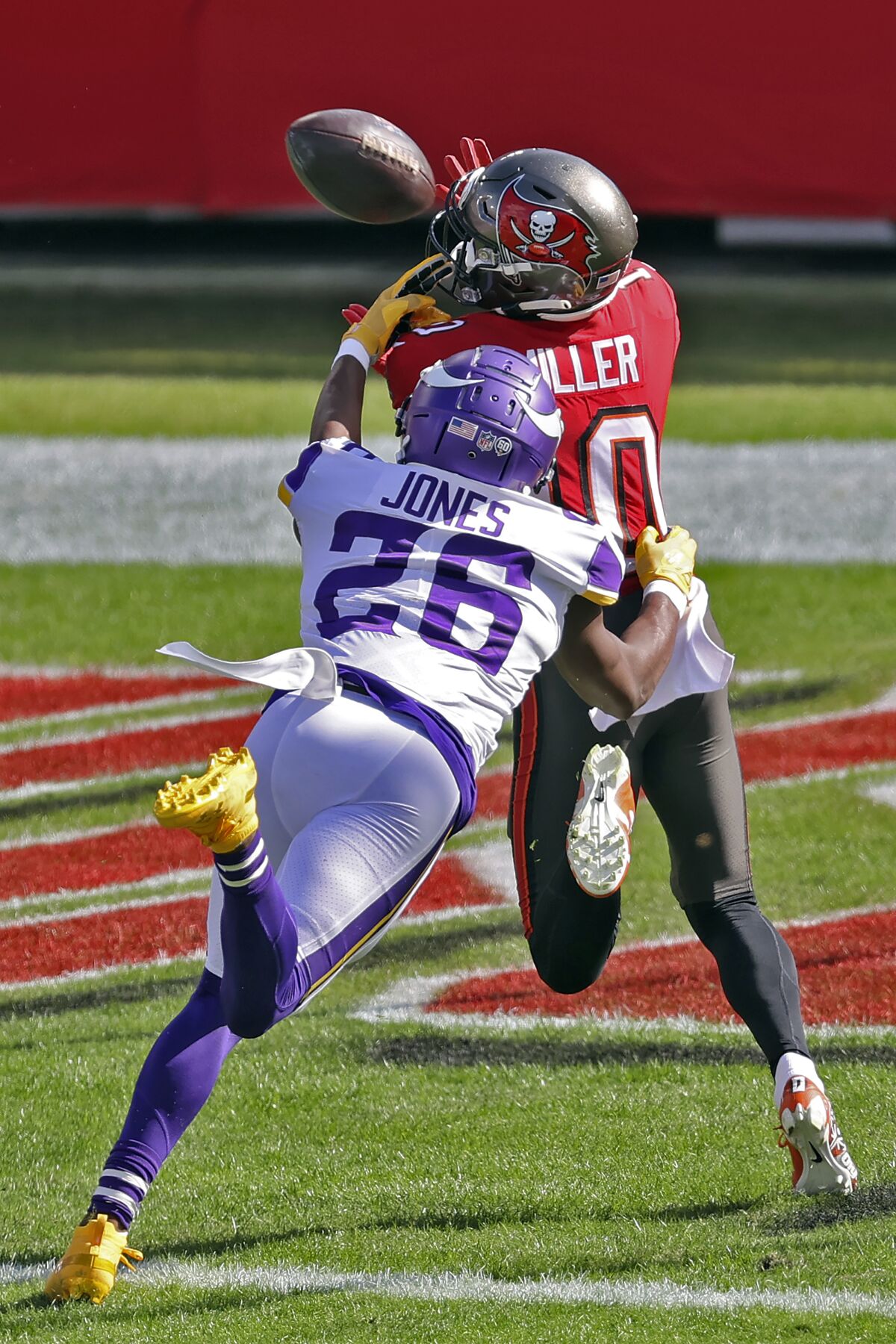 Tampa Bay Buccaneers wide receiver Scott Miller (10) pulls in a 48-yard touchdown pass from Tom Brady after getting in front of Minnesota Vikings defensive back Chris Jones (26) during the first half of an NFL football game Sunday, Dec. 13, 2020, in Tampa, Fla. (AP Photo/Mark LoMoglio)